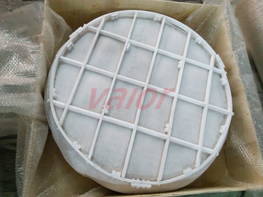 A PTFE demister pad is being loaded into a wooden box.