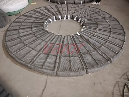 A annular demister is being pre-assembled on the ground.