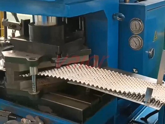 The metal sheet is being corrugated to make structured packing.