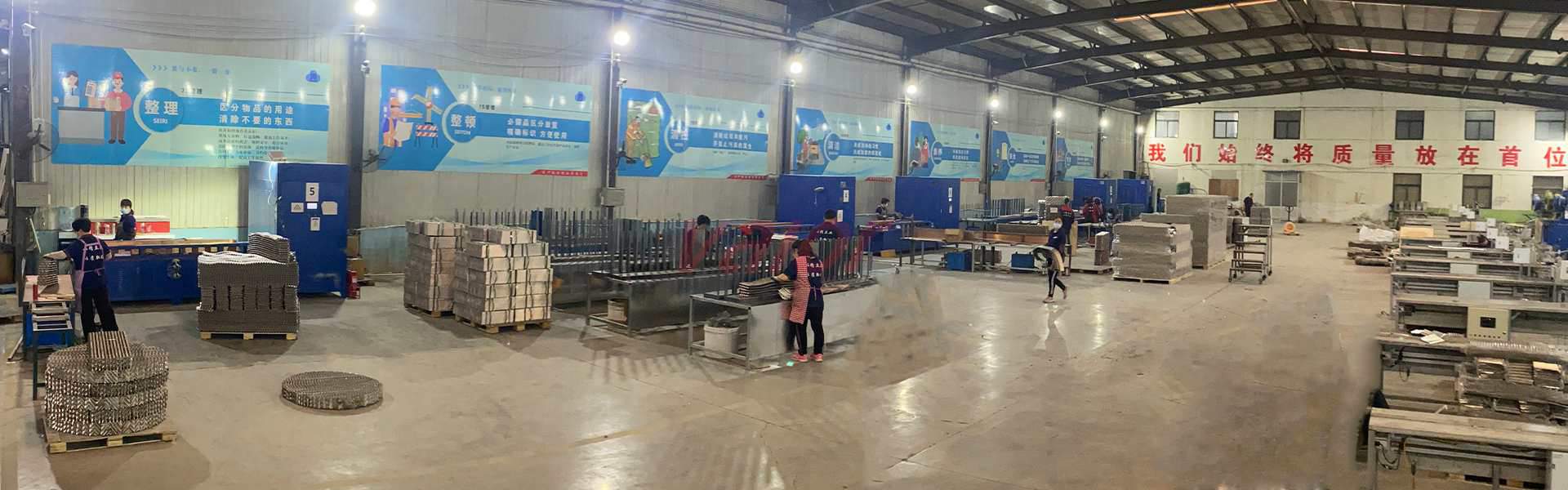 Ready metal sheets or wire mesh pieces are assembled into structured packing blocks here.